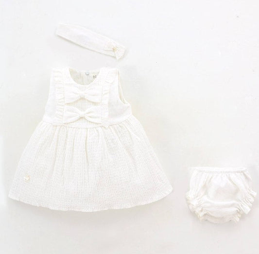 White baby dress and diaper on a white background with Leoking branding.